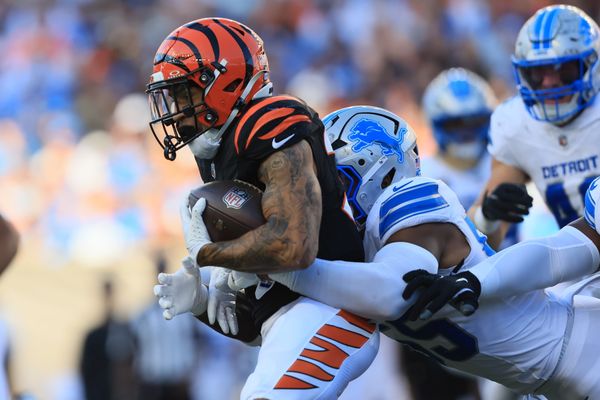 Oct 5, 2025; Cincinnati, Ohio, USA; Cincinnati Bengals running back Chase Brown (30) is tackled by Detroit Lions linebacker Derrick Barnes (55) during the second quarter at Paycor Stadium. Mandatory Credit: Katie Stratman-Imagn Images