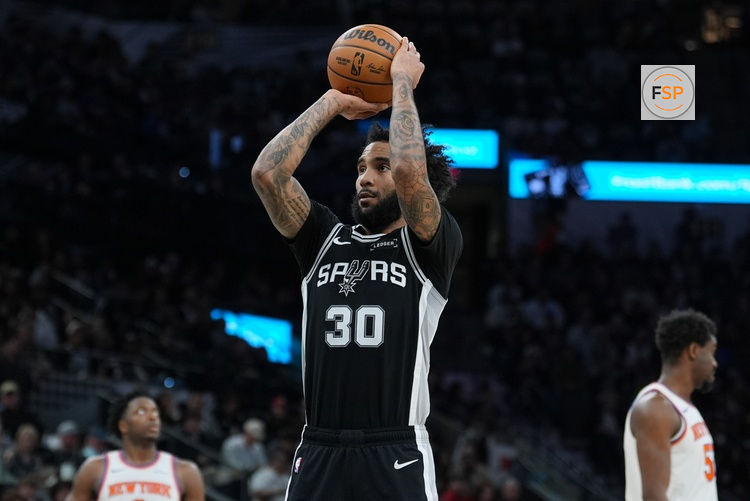 Dec 31, 2025; San Antonio, Texas, USA;  San Antonio Spurs forward Julian Champagnie (30) shoots a free throw in the first half against the New York Knicks at Frost Bank Center. Credit: Daniel Dunn-Imagn Images