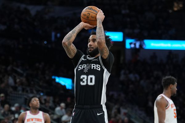 Dec 31, 2025; San Antonio, Texas, USA;  San Antonio Spurs forward Julian Champagnie (30) shoots a free throw in the first half against the New York Knicks at Frost Bank Center. Mandatory Credit: Daniel Dunn-Imagn Images