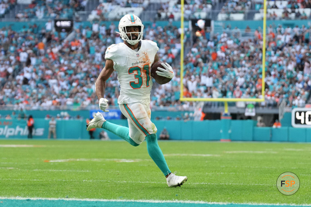 MIAMI GARDENS, FL - DECEMBER 17: Miami Dolphins running back Raheem Mostert (31) rushes for a touchdown in the first half during the game between the New York Jets and the Miami Dolphins on Sunday, December 17, 2023 at Hard Rock Stadium, Hard Rock Stadium, Fla. (Photo by Peter Joneleit/Icon Sportswire)