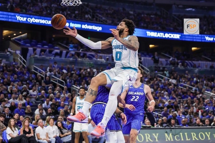 Apr 17, 2026; Orlando, Florida, USA; Charlotte Hornets forward Miles Bridges (0) is fouled by Orlando Magic guard Desmond Bane (3) during the second half during the play-in rounds of the 2026 NBA Playoffs at Kia Center. Credit: Mike Watters-Imagn Images