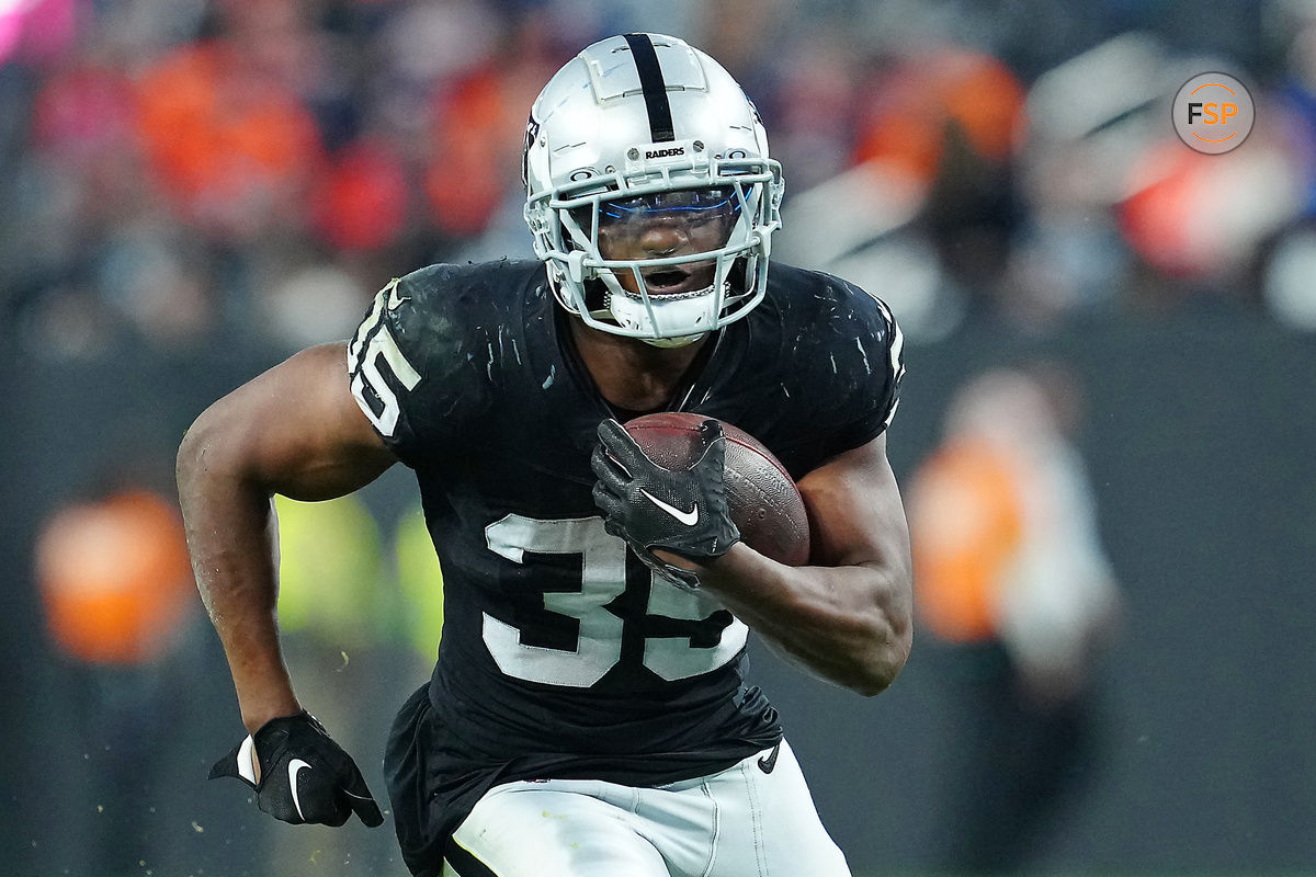 Jan 7, 2024; Paradise, Nevada, USA; Las Vegas Raiders running back Zamir White (35) gains yardage against the Denver Broncos during the fourth quarter at Allegiant Stadium. Credit: Stephen R. Sylvanie-USA TODAY Sports