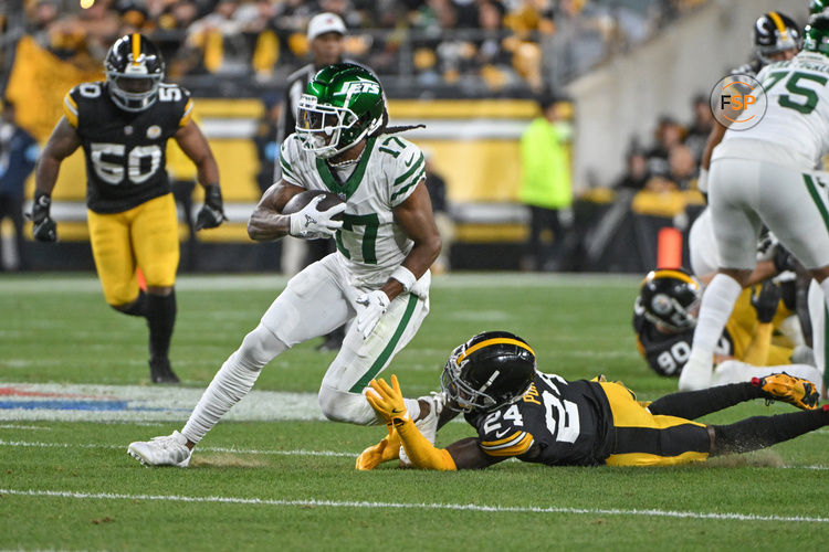 Oct 20, 2024; Pittsburgh, Pennsylvania, USA; NNew York Jets wide receiver Davante Adams (17) eludes Pittsburgh Steelers cornerback Joey Porter Jr. (24) on a pass during the first quarter at Acrisure Stadium. Credit: Barry Reeger-Imagn Images