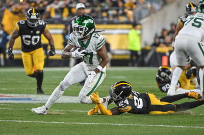 Oct 20, 2024; Pittsburgh, Pennsylvania, USA; NNew York Jets wide receiver Davante Adams (17) eludes Pittsburgh Steelers cornerback Joey Porter Jr. (24) on a pass during the first quarter at Acrisure Stadium. Mandatory Credit: Barry Reeger-Imagn Images