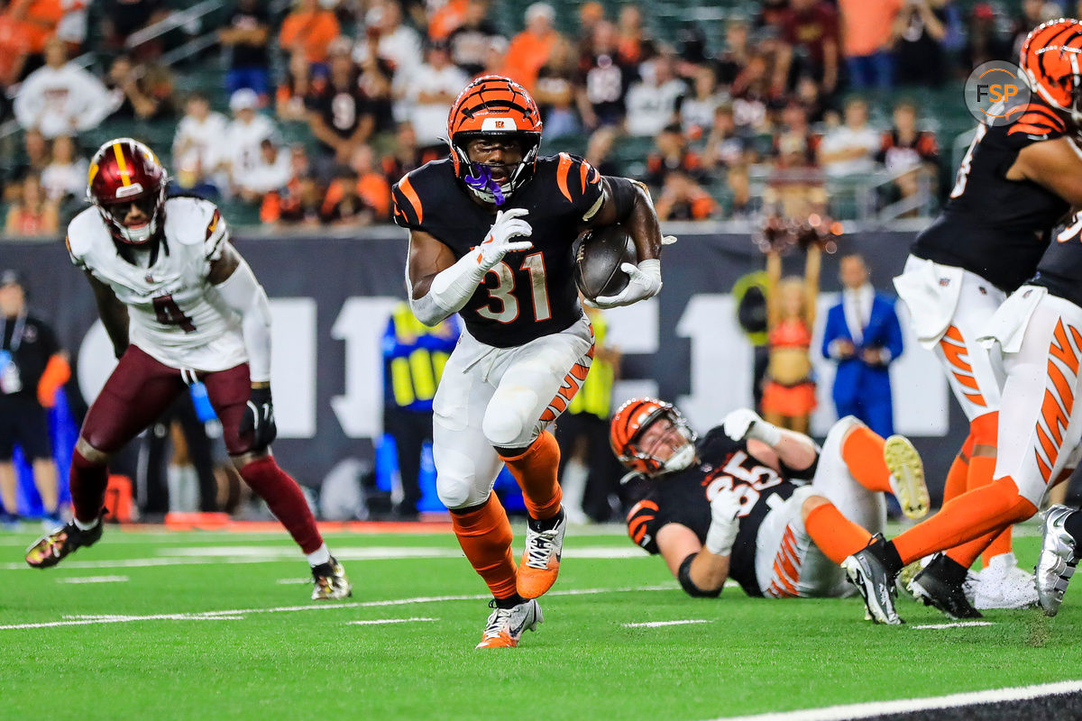 Sep 23, 2024; Cincinnati, Ohio, USA; Cincinnati Bengals running back Zack Moss (31) runs with the ball for a touchdown against the Washington Commanders in the second half at Paycor Stadium. Credit: Katie Stratman-Imagn Images