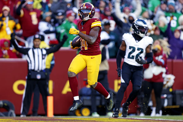 Dec 22, 2024; Landover, Maryland, USA; Washington Commanders wide receiver Olamide Zaccheaus (14) scores a touchdown during the fourth quarter against the Philadelphia Eagles at Northwest Stadium. Mandatory Credit: Peter Casey-Imagn Images