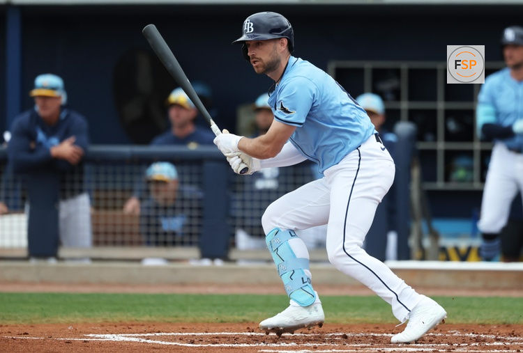 Feb 24, 2025; Port Charlotte, Florida, USA;  Tampa Bay Rays second base Brandon Lowe (8) singles against the Minnesota Twins during the first inning at Charlotte Sports Park. Credit: Kim Klement Neitzel-Imagn Images