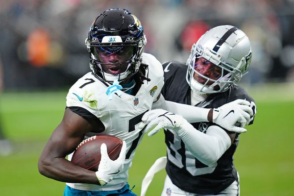 Dec 22, 2024; Paradise, Nevada, USA; Las Vegas Raiders cornerback Darnay Holmes (30) looks to knock the ball away from Jacksonville Jaguars wide receiver Brian Thomas Jr. (7) during the second quarter at Allegiant Stadium. Mandatory Credit: Stephen R. Sylvanie-Imagn Images