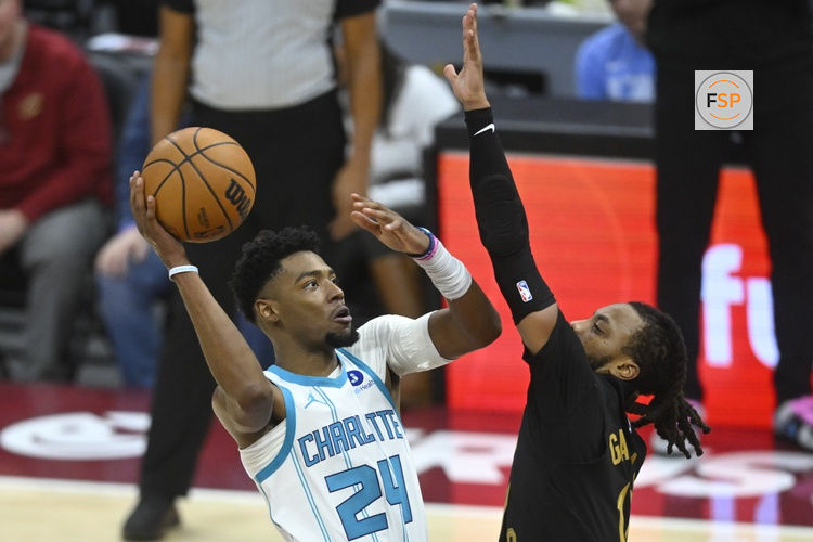 Dec 14, 2025; Cleveland, Ohio, USA; Charlotte Hornets forward Brandon Miller (24) shoots beside Cleveland Cavaliers guard Darius Garland (10) in the fourth quarter at Rocket Arena. Credit: David Richard-Imagn Images