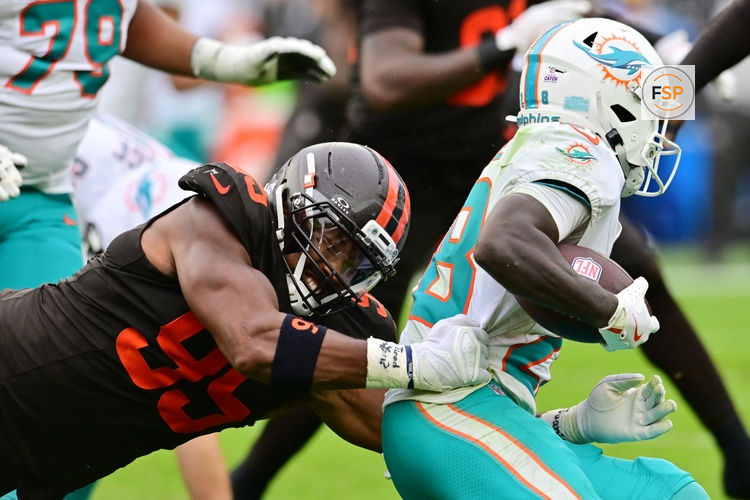 Oct 19, 2025; Cleveland, Ohio, USA; Cleveland Browns defensive end Myles Garrett (95) tackles Miami Dolphins running back De'Von Achane (28) during the second half at Huntington Bank Field. Credit: Ken Blaze-Imagn Images