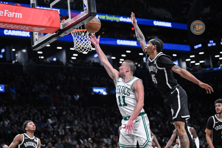 Mar 15, 2025; Brooklyn, New York, USA; Boston Celtics guard Payton Pritchard (11) drives to the basket while being defended by Brooklyn Nets guard Keon Johnson (45) during the second half at Barclays Center. Credit: John Jones-Imagn Images