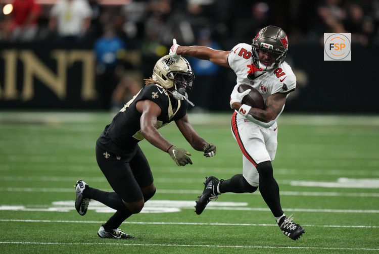 Oct 26, 2025; New Orleans, Louisiana, USA;  Tampa Bay Buccaneers wide receiver Emeka Egbuka (2) runs for a gain past New Orleans Saints cornerback Quincy Riley (29) during the third quarter at Caesars Superdome. Credit: Matthew Hinton-Imagn Images