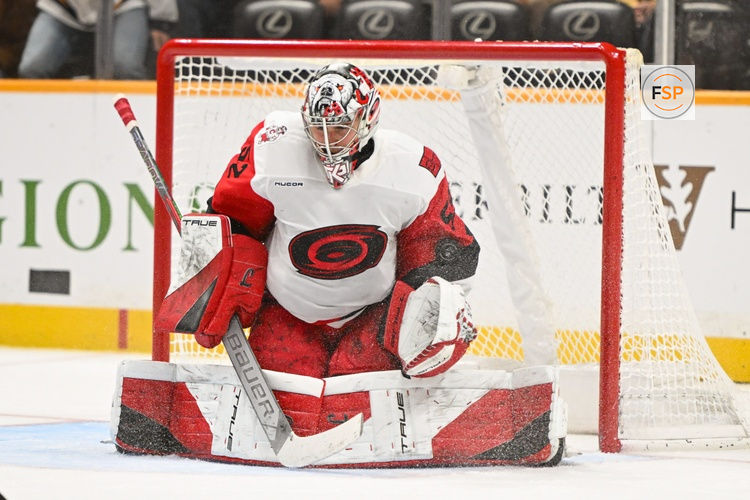 Dec 17, 2025; Nashville, Tennessee, USA;  Carolina Hurricanes goaltender Pyotr Kochetkov (52) stops the puck against the Nashville Predators during the third period at Bridgestone Arena. Credit: Steve Roberts-Imagn Images