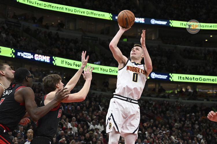 Jan 27, 2025; Chicago, Illinois, USA;  Denver Nuggets guard Christian Braun (0) shoots against the Chicago Bulls during the second half at the United Center. Credit: Matt Marton-Imagn Images