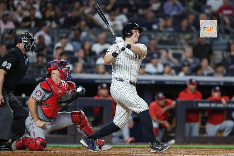 Aug 25, 2025; Bronx, New York, USA;  New York Yankees catcher Ben Rice (22) hits a solo home run in the third inning against the Washington Nationals at Yankee Stadium. Credit: Wendell Cruz-Imagn Images
