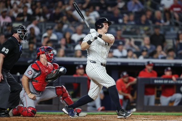 Aug 25, 2025; Bronx, New York, USA;  New York Yankees catcher Ben Rice (22) hits a solo home run in the third inning against the Washington Nationals at Yankee Stadium. Mandatory Credit: Wendell Cruz-Imagn Images