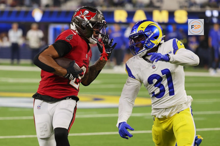 Nov 23, 2025; Inglewood, California, USA; Tampa Bay Buccaneers wide receiver Emeka Egbuka (2) runs with the ball against Los Angeles Rams cornerback Darious Williams (31) during the fourth quarter at SoFi Stadium. Credit: Kiyoshi Mio-Imagn Images