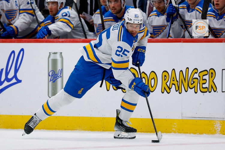 Apr 5, 2026; Denver, Colorado, USA; St. Louis Blues right wing Jordan Kyrou (25) controls the puck in the third period against the Colorado Avalanche at Ball Arena. Credit: Isaiah J. Downing-Imagn Images
