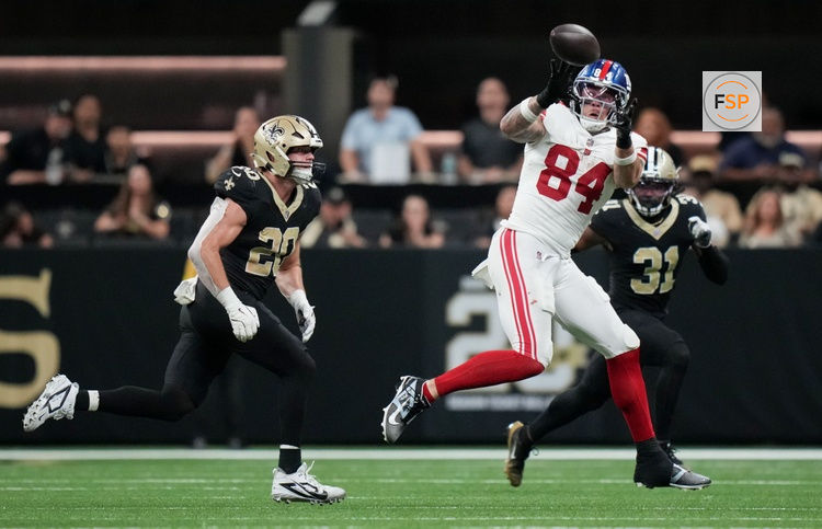 Oct 5, 2025; New Orleans, Louisiana, USA; New York Giants tight end Theo Johnson (84) catches a pass against New Orleans Saints linebacker Pete Werner (20) at Caesars Superdome. Credit: Matthew Hinton-Imagn Images