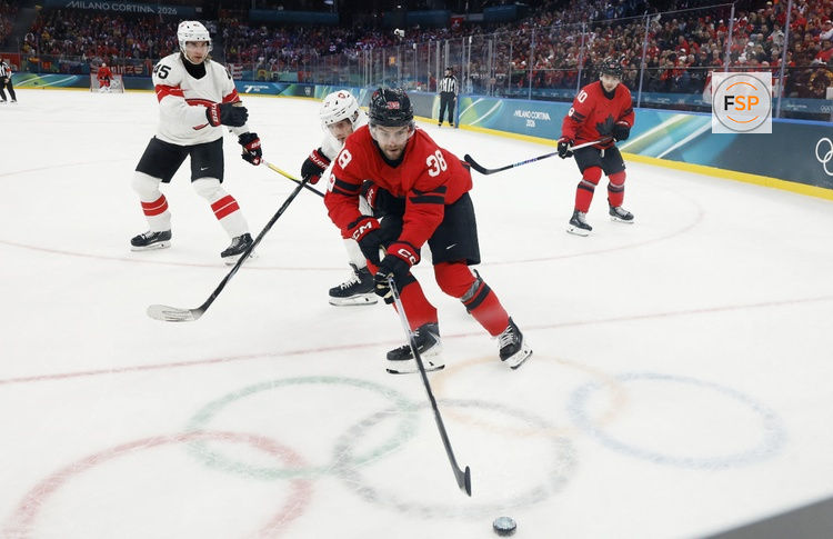 Feb 13, 2026; Milan, Italy; Brandon Hagel of Canada in action with Kevin Fiala of Switzerland  in men's ice hockey group A play during the Milano Cortina 2026 Olympic Winter Games at Milano Santagiulia Ice Hockey Arena. Credit: Geoff Burke-Imagn Images