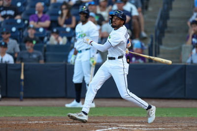 Apr 19, 2025; Tampa, Florida, USA; Tampa Bay Rays center fielder Chandler Simpson (14) doubles against the New York Yankees in the ninth inning at George M. Steinbrenner Field. Mandatory Credit: Nathan Ray Seebeck-Imagn Images