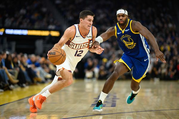 Nov 4, 2025; San Francisco, California, USA; Phoenix Suns guard Collin Gillespie (12) dribbles against Golden State Warriors guard Buddy Hield (7) in the second quarter at Chase Center. Mandatory Credit: Eakin Howard-Imagn Images