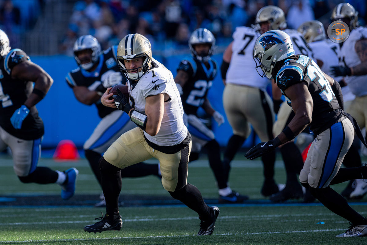 Nov 3, 2024; Charlotte, North Carolina, USA; New Orleans Saints tight end Taysom Hill (7) turns upfield against Carolina Panthers safety Demani Richardson (36) during the fourth quarter at Bank of America Stadium. Credit: Scott Kinser-Imagn Images