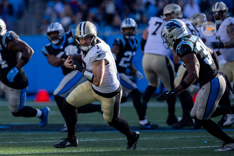 Nov 3, 2024; Charlotte, North Carolina, USA; New Orleans Saints tight end Taysom Hill (7) turns upfield against Carolina Panthers safety Demani Richardson (36) during the fourth quarter at Bank of America Stadium. Credit: Scott Kinser-Imagn Images