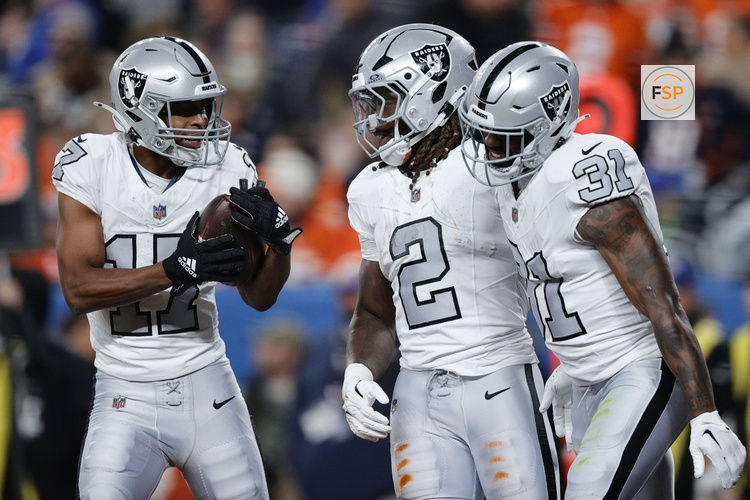 Nov 6, 2025; Denver, Colorado, USA; Las Vegas Raiders wide receiver Tyler Lockett (17) reacts with running back Ashton Jeanty (2) and running back Raheem Mostert (31) during the first half at Empower Field at Mile High. Credit: Isaiah J. Downing-Imagn Images