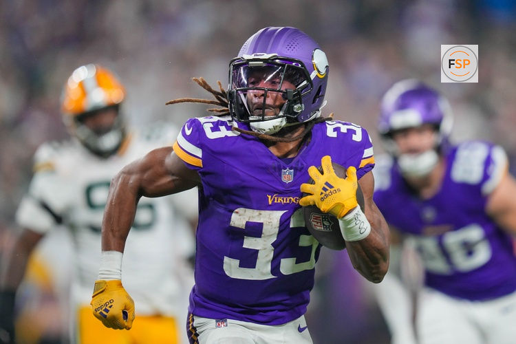 Dec 29, 2024; Minneapolis, Minnesota, USA; Minnesota Vikings running back Aaron Jones (33) runs with the ball against Green Bay Packers in the third quarter at U.S. Bank Stadium. Credit: Brad Rempel-Imagn Images