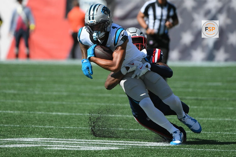 Sep 28, 2025; Foxborough, Massachusetts, USA; New England Patriots safety Jaylinn Hawkins (21) tackles Carolina Panthers wide receiver Tetairoa McMillan (4)  during the first half at Gillette Stadium. Credit: Bob DeChiara-Imagn Images