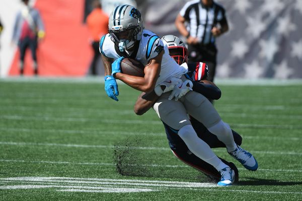 Sep 28, 2025; Foxborough, Massachusetts, USA; New England Patriots safety Jaylinn Hawkins (21) tackles Carolina Panthers wide receiver Tetairoa McMillan (4)  during the first half at Gillette Stadium. Mandatory Credit: Bob DeChiara-Imagn Images