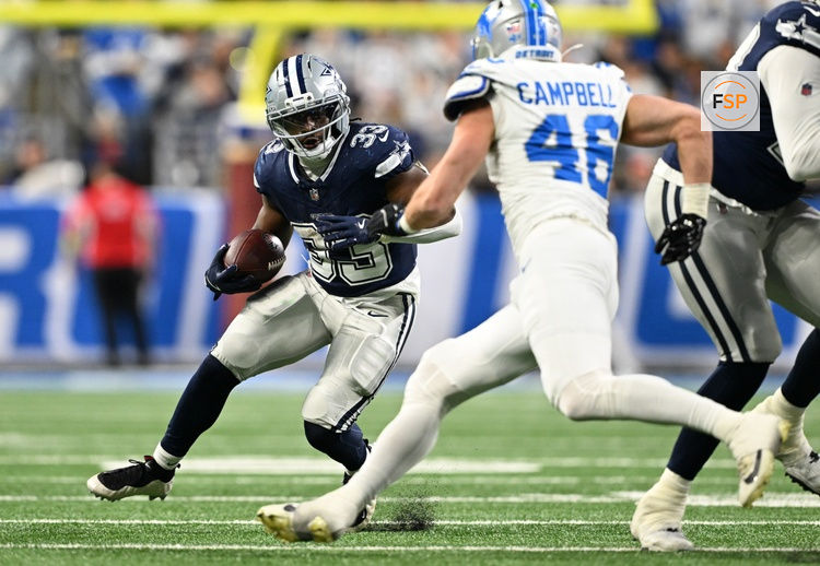 Dec 4, 2025; Detroit, Michigan, USA; Dallas Cowboys running back Javonte Williams (33) runs against Detroit Lions linebacker Jack Campbell (46) during the first half at Ford Field. Credit: Lon Horwedel-Imagn Images
