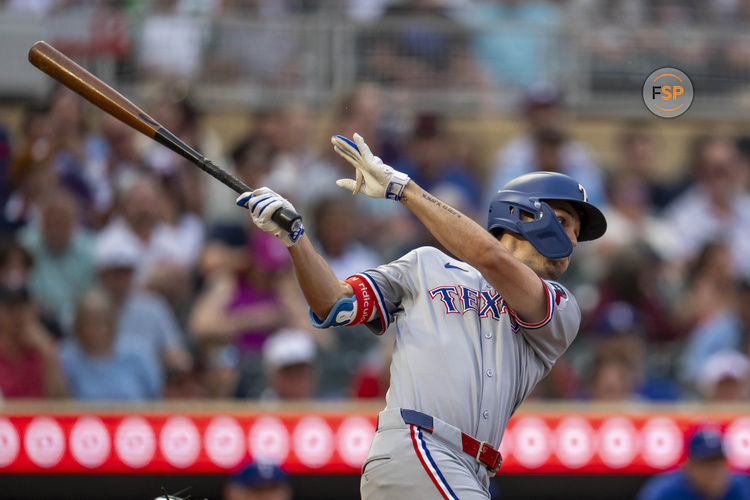 Jun 10, 2025; Minneapolis, Minnesota, USA; Texas Rangers center fielder Evan Carter (32) hits a single against the Minnesota Twins in the fifth inning at Target Field. Credit: Jesse Johnson-Imagn Images