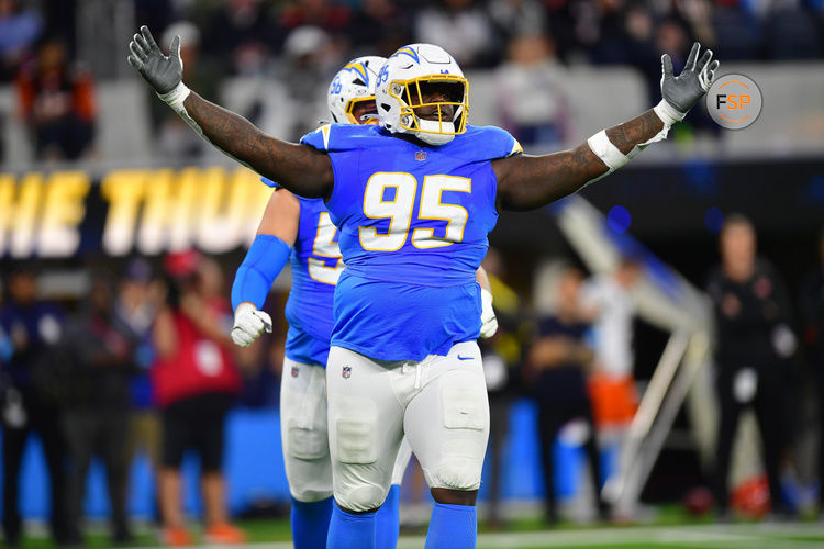 Nov 17, 2024; Inglewood, California, USA; Los Angeles Chargers defensive tackle Poona Ford (95) reacts after sacking Cincinnati Bengals quarterback Joe Burrow (9) during the first half at SoFi Stadium. Credit: Gary A. Vasquez-Imagn Images