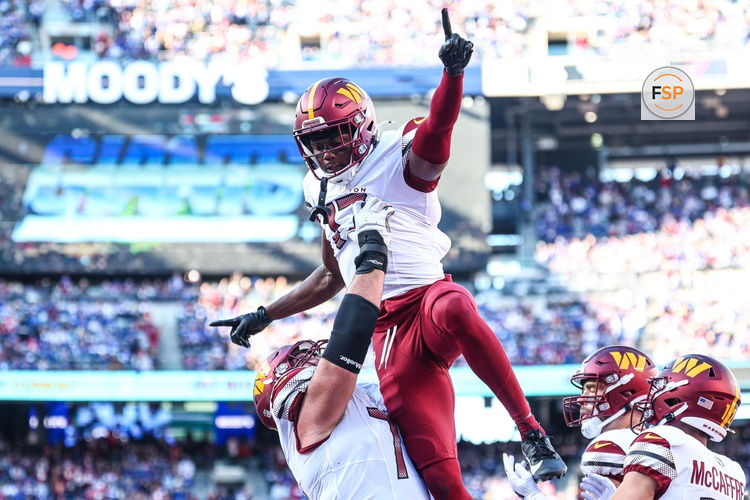 Nov 3, 2024; East Rutherford, New Jersey, USA;  Washington Commanders wide receiver Terry McLaurin (17) celebrates after a touchdown reception with guard Sam Cosmi (76) during the first half against the New York Giants at MetLife Stadium. Credit: Vincent Carchietta-Imagn Images