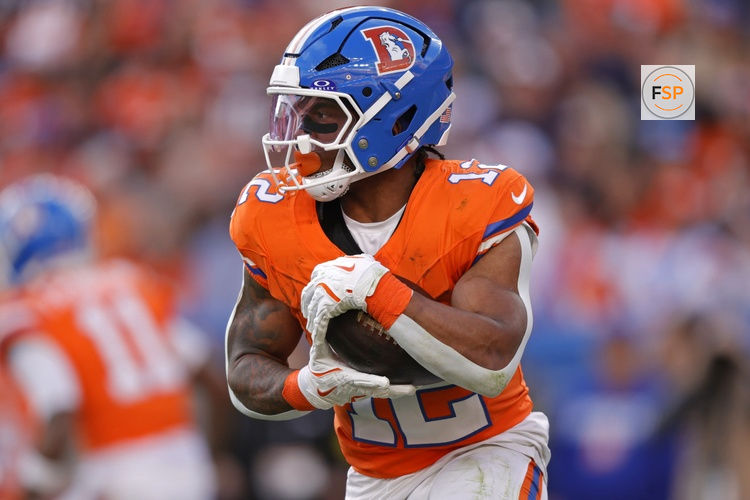 Jan 4, 2026; Denver, Colorado, USA; Denver Broncos running back RJ Harvey (12) runs with the ball during the game against the Los Angeles Chargers during the first half at Empower Field at Mile High. Credit: Isaiah J. Downing-Imagn Images