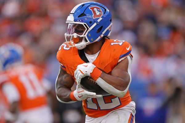 Jan 4, 2026; Denver, Colorado, USA; Denver Broncos running back RJ Harvey (12) runs with the ball during the game against the Los Angeles Chargers during the first half at Empower Field at Mile High. Mandatory Credit: Isaiah J. Downing-Imagn Images