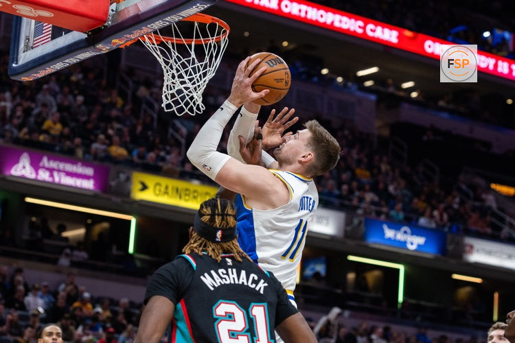Mar 1, 2026; Indianapolis, Indiana, USA; Indiana Pacers center Micah Potter (11) shoots the ball while  Memphis Grizzlies guard Jahmai Mashack (21) defends in the first half at Gainbridge Fieldhouse. Credit: Trevor Ruszkowski-Imagn Images