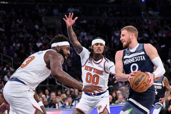 Oct 9, 2025; New York, New York, USA; Minnesota Timberwolves guard Donte Divincenzo tries to get past New York Knicks center/forward Mitchell Robinson (23) and guard Jordan Clarkson (00) during the first half at Madison Square Garden. Mandatory Credit: John Jones-Imagn Images