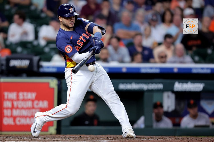 Apr 2, 2025; Houston, Texas, USA; Houston Astros catcher Yainer Diaz (21) hits an infield single against the San Francisco Giants during the fourth inning at Daikin Park. Credit: Erik Williams-Imagn Images
