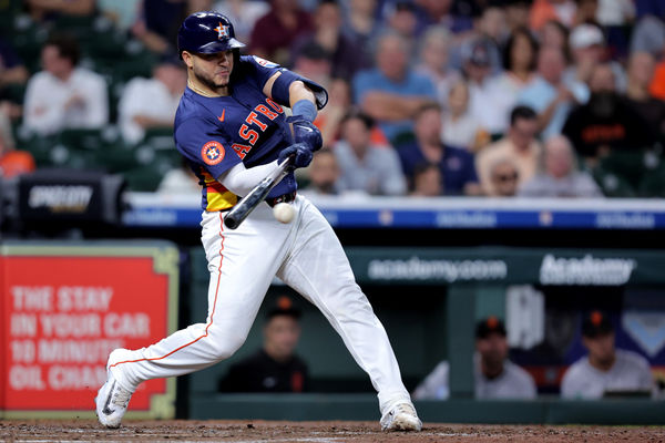 Apr 2, 2025; Houston, Texas, USA; Houston Astros catcher Yainer Diaz (21) hits an infield single against the San Francisco Giants during the fourth inning at Daikin Park. Mandatory Credit: Erik Williams-Imagn Images
