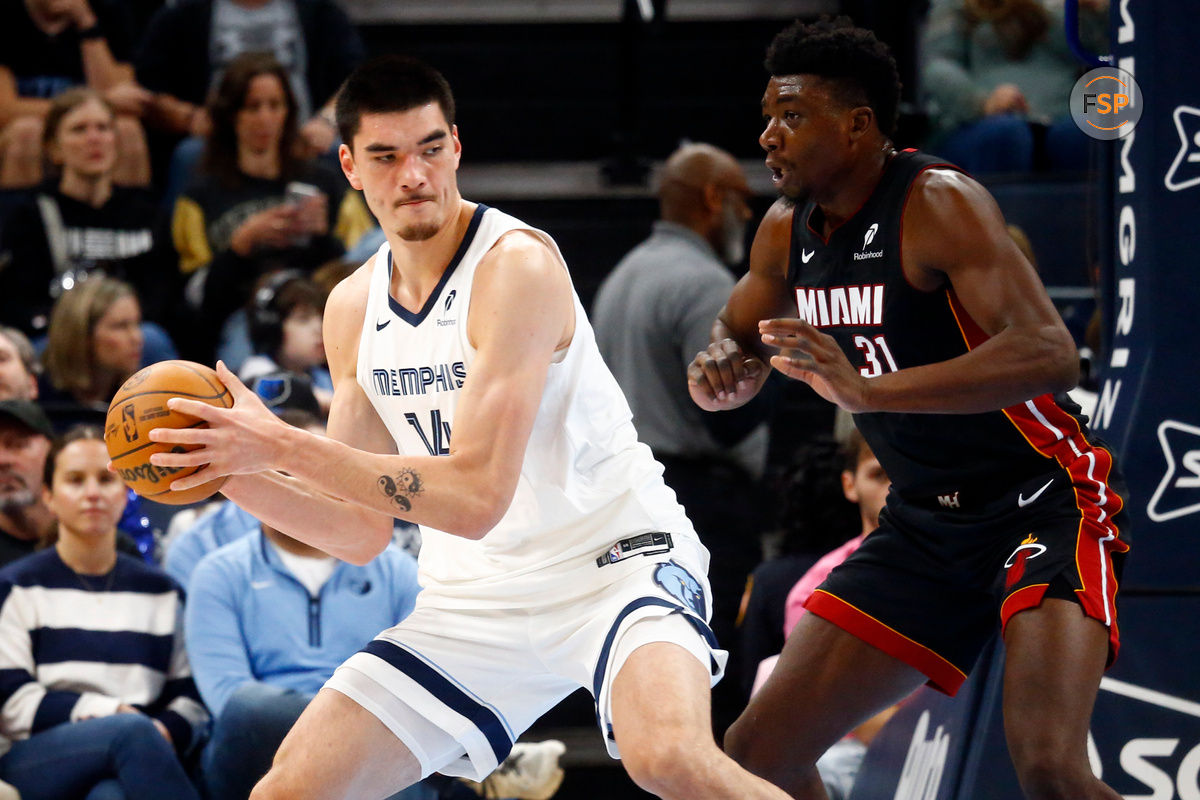 Oct 18, 2024; Memphis, Tennessee, USA; Memphis Grizzlies center Zach Edey (14) spins toward the basket as Miami Heat center Thomas Bryant (31) defends during the first half at FedExForum. Credit: Petre Thomas-Imagn Images