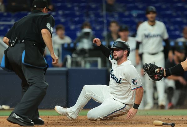 Mar 31, 2026; Miami, Florida, USA; Miami Marlins first baseman Liam Hicks (34) slides at home plate and scores against the Chicago White Sox during the eighth inning at loanDepot Park. Mandatory Credit: Sam Navarro-Imagn Images