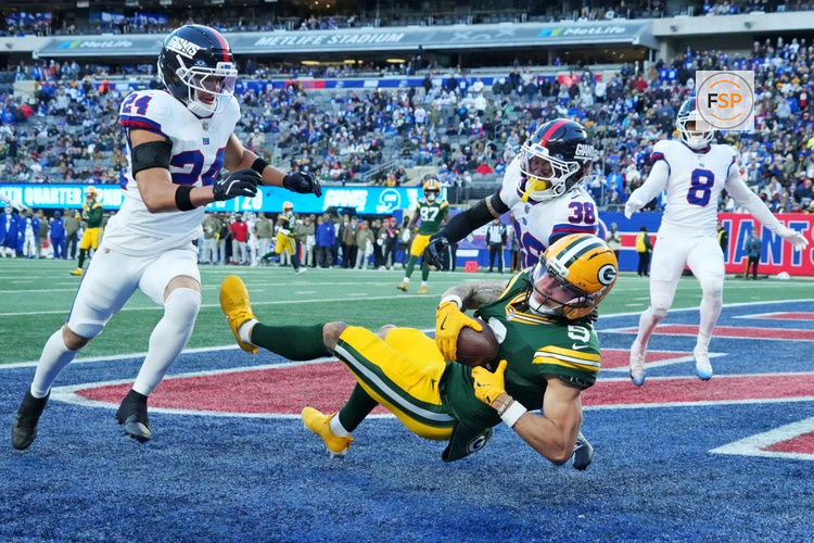 Nov 16, 2025; East Rutherford, New Jersey, USA; Green Bay Packers wide receiver Christian Watson (9) makes a touchdown catch against New York Giants cornerback Korie Black (38) during the fourth quarter during the fourth quarter at MetLife Stadium. Credit: Robert Deutsch-Imagn Images