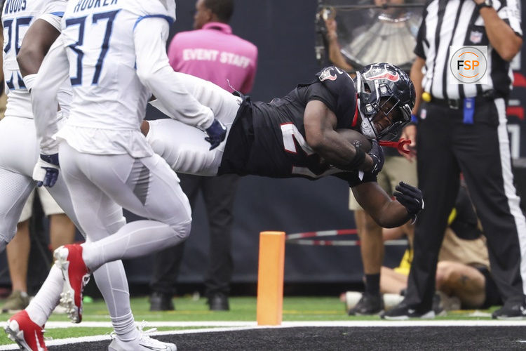 Sep 28, 2025; Houston, Texas, USA; Houston Texans running back Woody Marks (27) dives into the end zone for a touchdown during the fourth quarter against the Tennessee Titans at NRG Stadium. Credit: Troy Taormina-Imagn Images