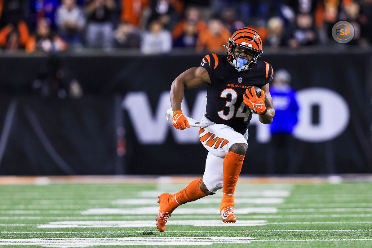 Dec 28, 2024; Cincinnati, Ohio, USA; Cincinnati Bengals running back Khalil Herbert (34) runs with the ball against the Denver Broncos in overtime at Paycor Stadium. Credit: Katie Stratman-Imagn Images