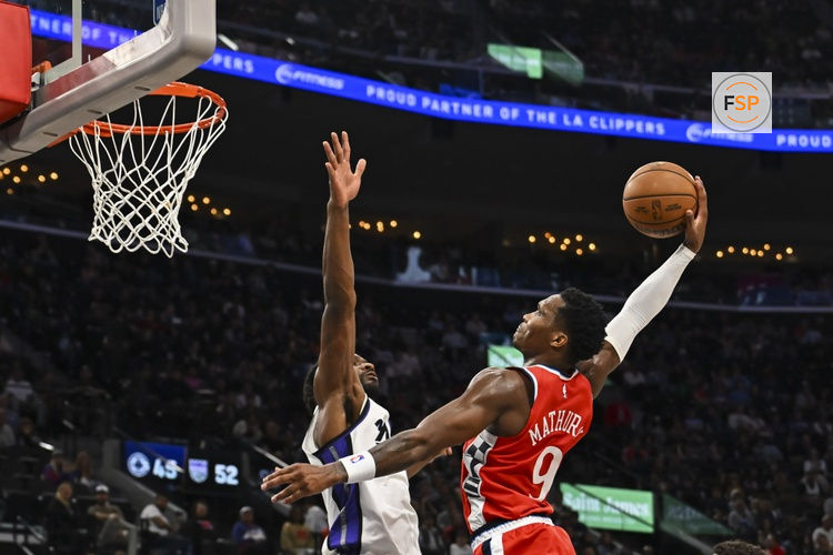 Mar 14, 2026; Inglewood, California, USA; LA Clippers guard-forward Bennedict Mathurin (9) dunks against Sacramento Kings forward Precious Achiuwa (9) during the second quarter at Intuit Dome. Credit: Jonathan Hui-Imagn Images