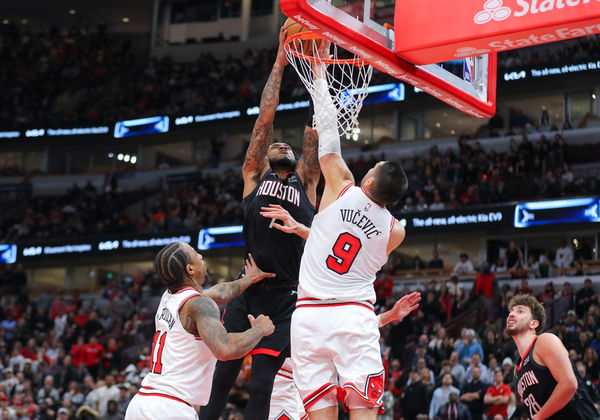 CHICAGO, IL - JANUARY 10: Nikola Vucevic #9 of the Chicago Bulls blocks Cam Whitmore #7 of the Houston Rockets slam dunk during the overtime at the United Center on January 10, 2024 in Chicago, Illinois. (Photo by Melissa Tamez/Icon Sportswire)