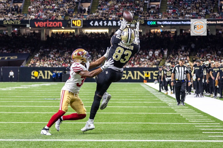Sep 14, 2025; New Orleans, Louisiana, USA; New Orleans Saints tight end Juwan Johnson (83) catches a touchdown against San Francisco 49ers safety Marques Sigle (36) during the first half at Caesars Superdome. Credit: Stephen Lew-Imagn Images
